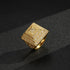 Gold pyramid ring with a 25mm top view on a reflective surface